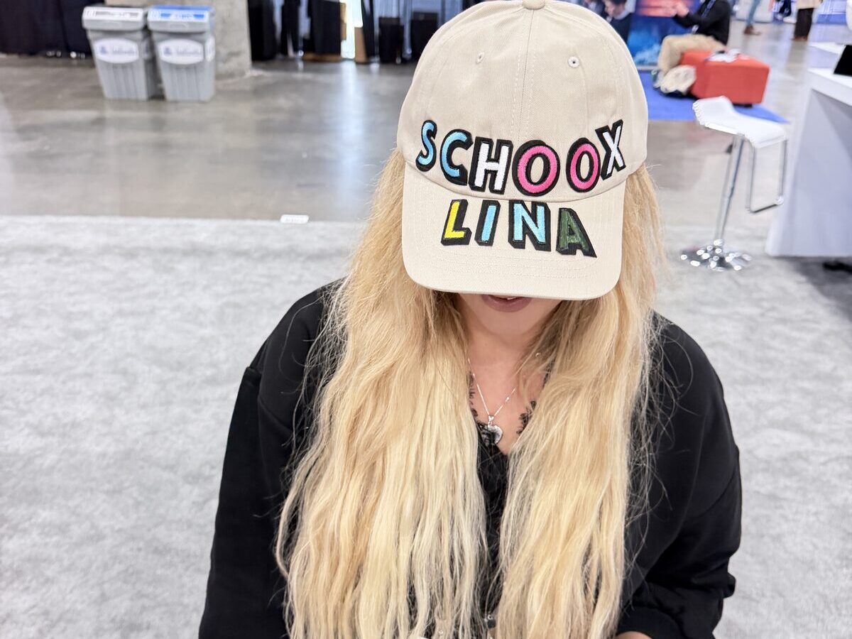 Event guest wearing a custom hand-lettered cap made at a live hat bar